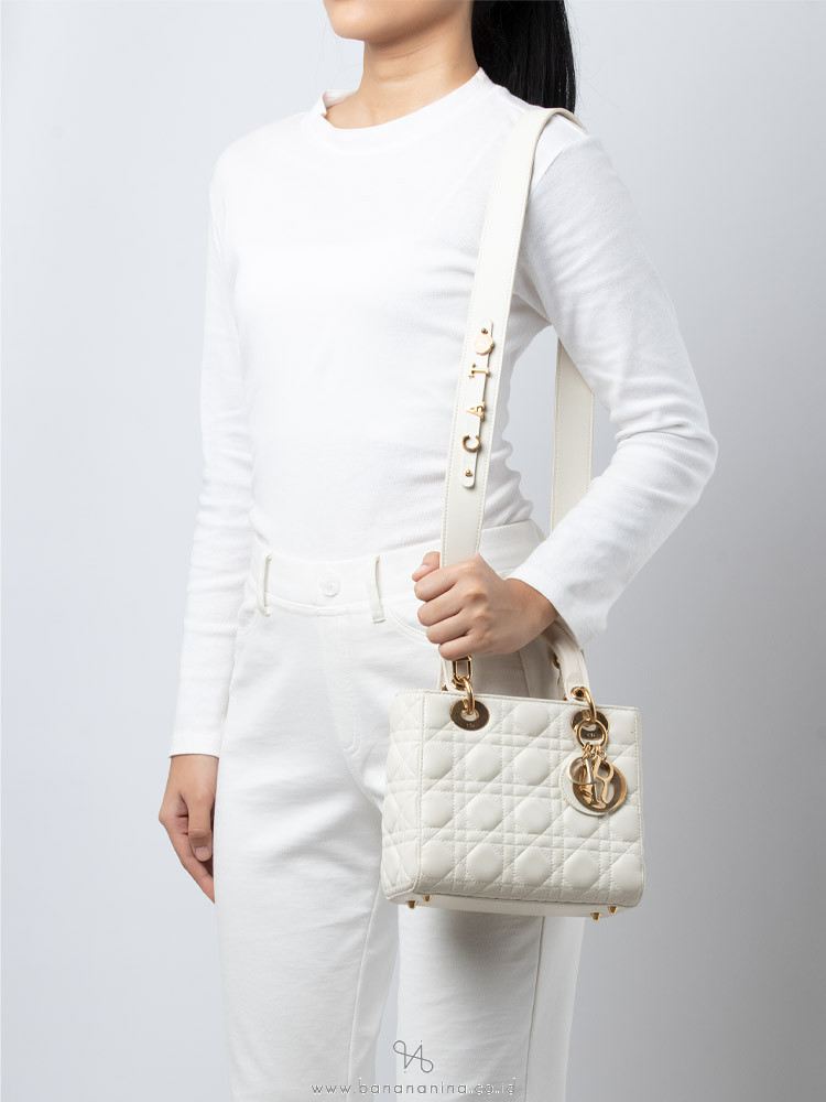 A guest wears a white coat a white outfit a Lady Dior bag flare News  Photo  Getty Images